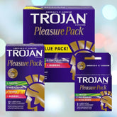 A range of Trojan Pleasure Pack Variety Condoms by Trojan is displayed against a blurred background. The packaging showcases different features such as "Twisted," "Her Pleasure," "Intense," and "Warming," promising an exhilarating experience. The packs predominantly feature purple and yellow colors.